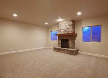 A stone fireplace becomes the focal point of a basement family room.